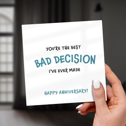 Hand holding a card with humorous anniversary message.