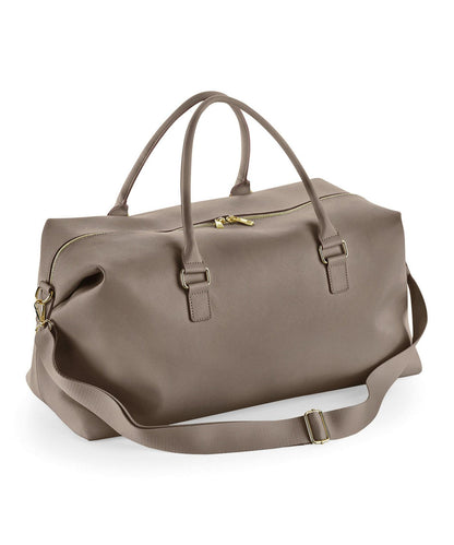 Brown duffel bag with a shoulder strap on a white background