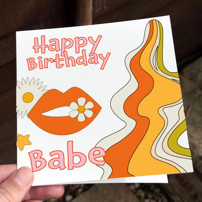 Birthday card with lips, flowers, and wavy lines on a white background