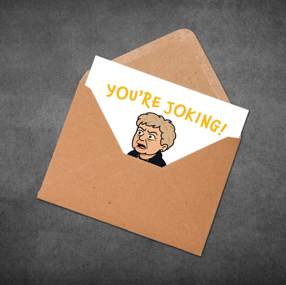 Envelope with a card inside that says 'You're Joking!' on a dark gray background