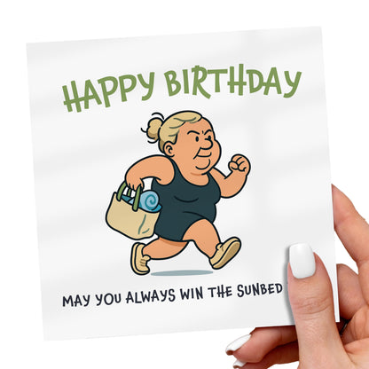 Birthday card with cartoon character and humorous text, held by a hand.
