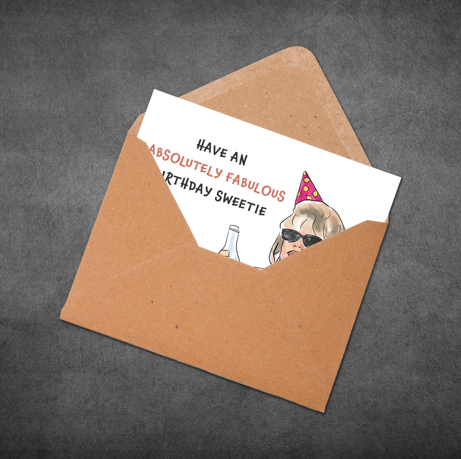Birthday card with a cartoon dog wearing sunglasses and a party hat, inside an open brown envelope on a dark gray background.
