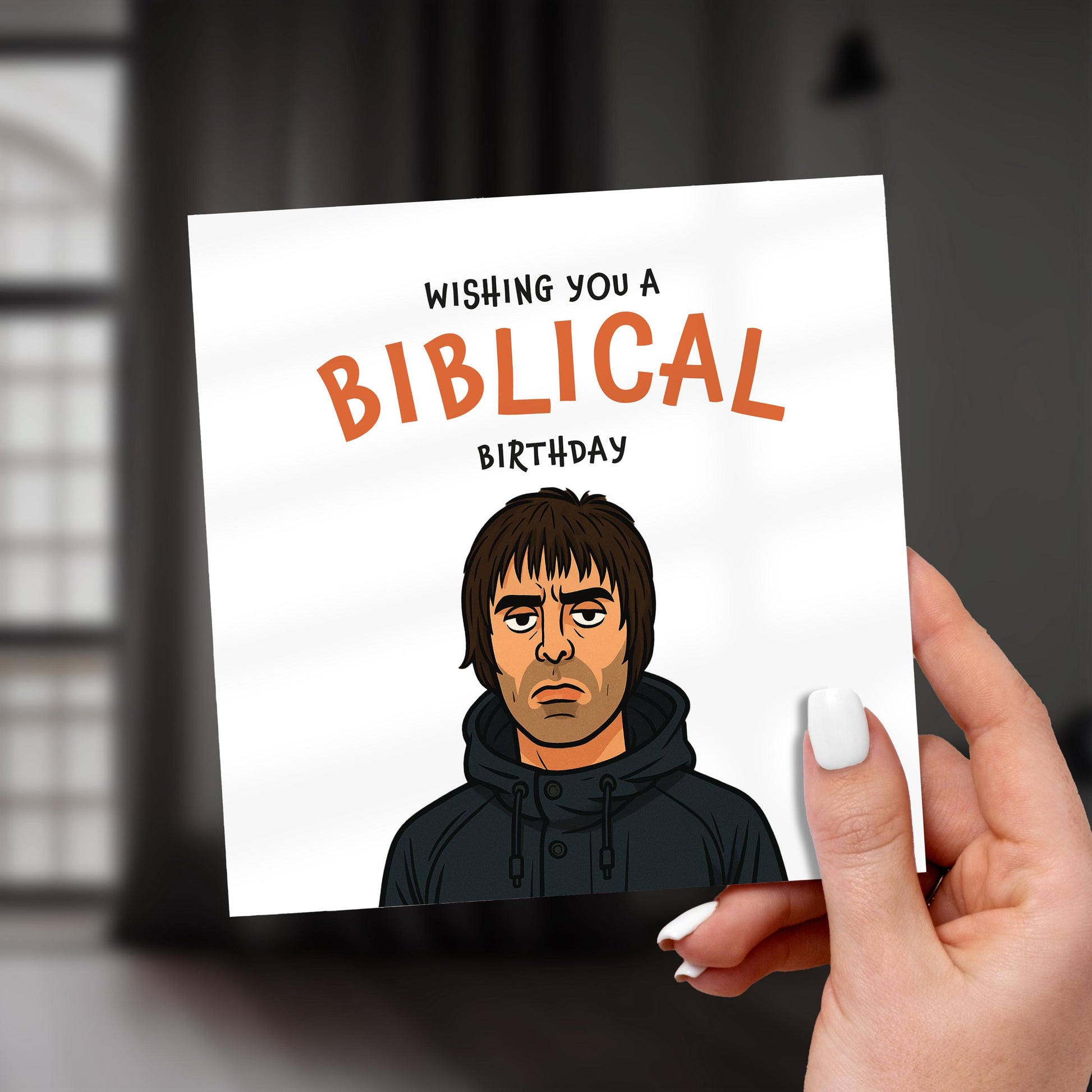 Card with a cartoon character and 'Wishing you a Biblical birthday' text, held by a hand.