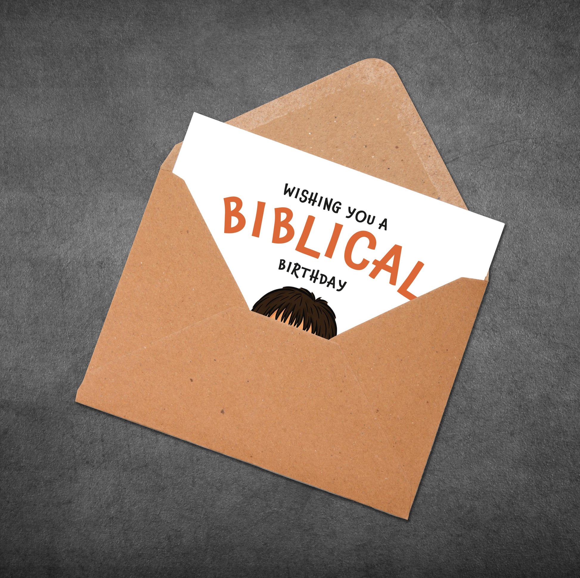 Brown envelope with a white card inside displaying 'Wishing you a Biblical Birthday' text.