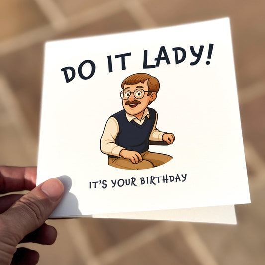 Square illustrated card showing a cartoon character resembling Chit — glasses, bowl cut, moustache, sweater vest — seated and smiling awkwardly. Bold text above reads “DO IT LADY!” and below, “IT’S YOUR BIRTHDAY.” The tone is silly, quirky, and based on viral internet sketch comedy.