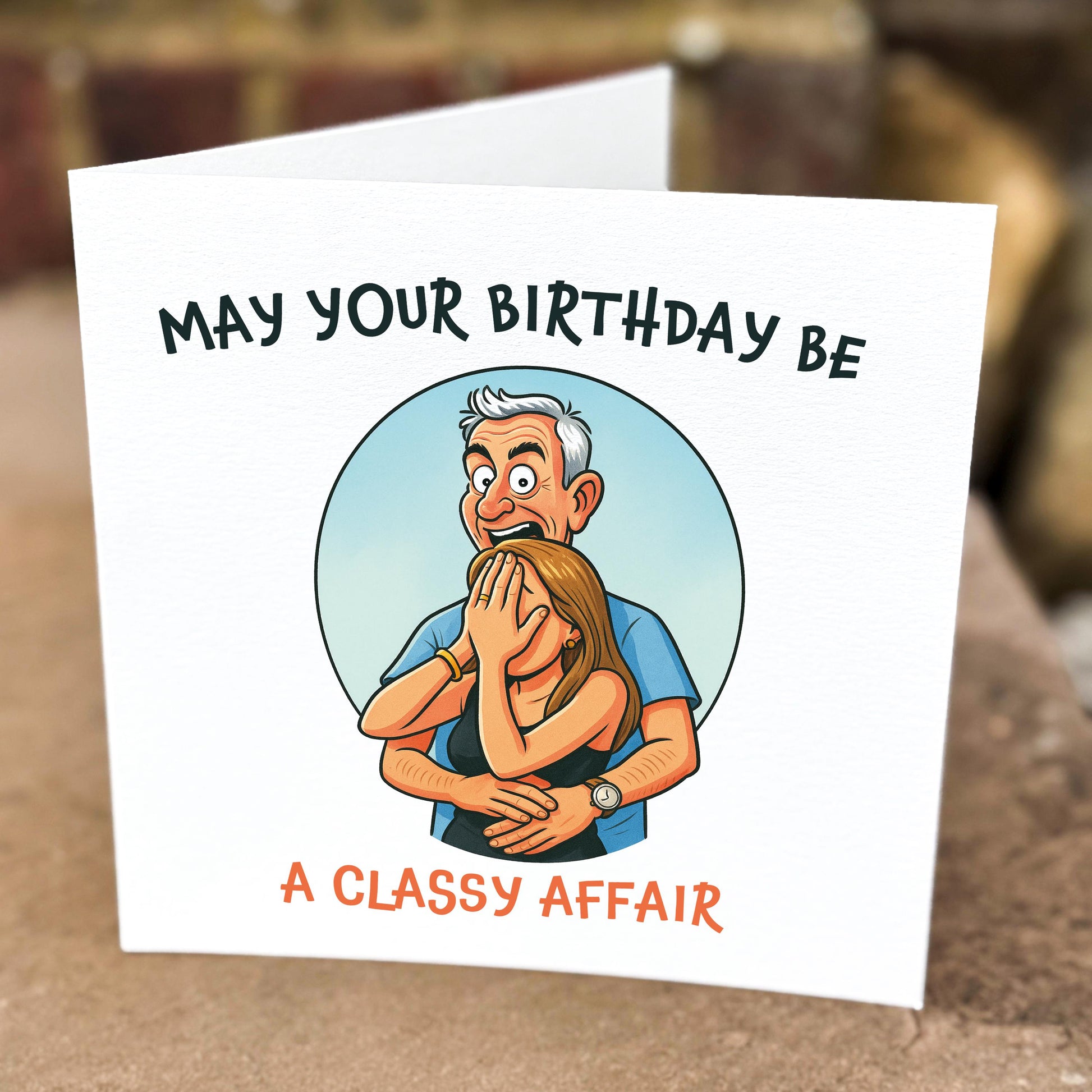 Birthday card with cartoon illustration of a man covering a woman's eyes, text 'May your birthday be a classy affair'.