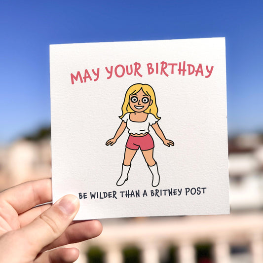 Funny birthday card featuring a cartoon-style Britney Spears in shorts, crop top and boots, referencing her wild Instagram dancing posts with the caption “May your birthday be wilder than a Britney post.”