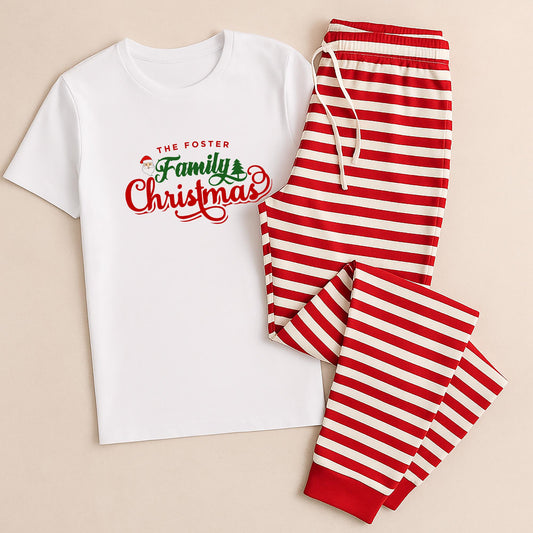 White t-shirt with 'The Foster Family Christmas' text and red and white striped pants on a beige background